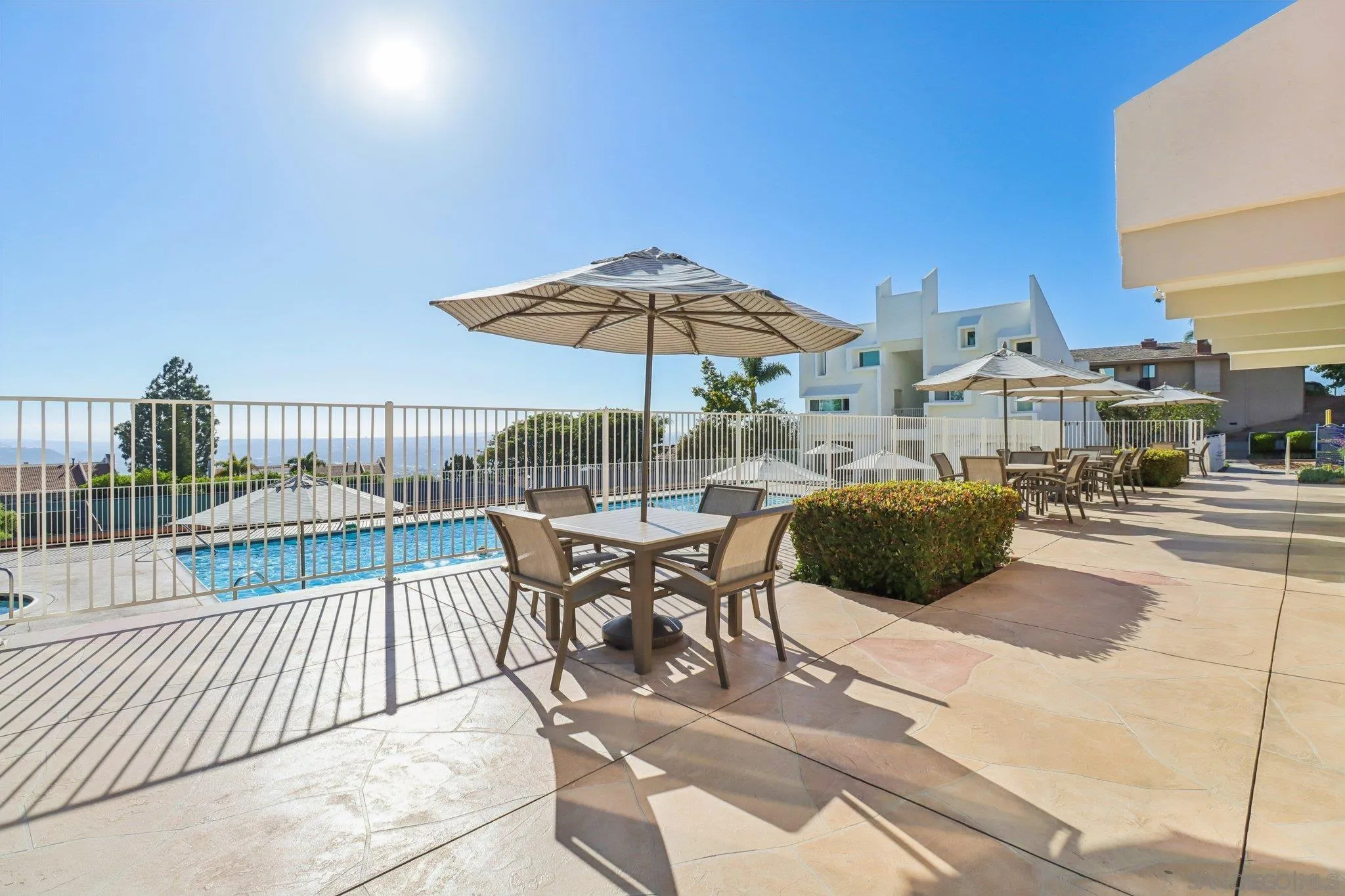 6329 Caminito Estrellado San Diego, CA 92120 - Photo 55 of 61 a view of a patio with a table and chairs under an umbrella
