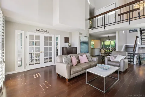 a living room with furniture a rug and a window