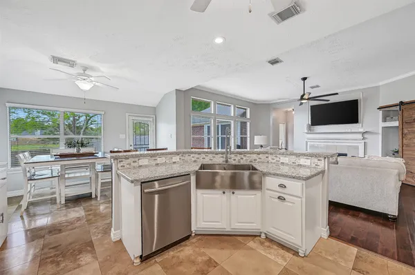a kitchen with stainless steel appliances granite countertop a stove and cabinets