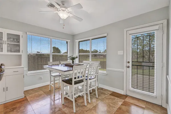 a view of a dining room with furniture and window