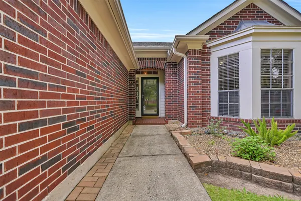 a view of a brick house with many windows