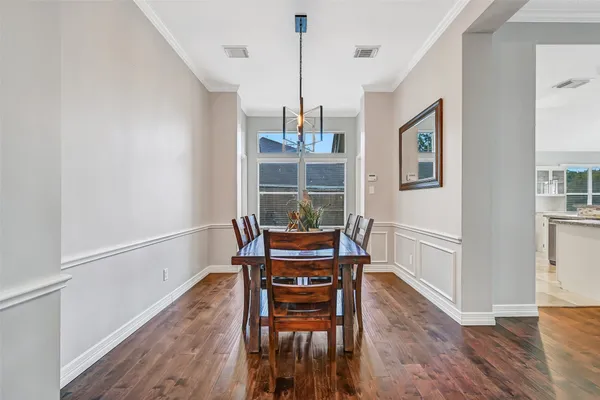 a dining room with furniture and wooden floor