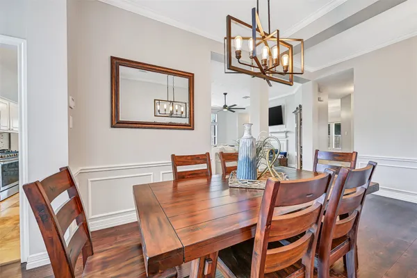 a view of a dining room with furniture wooden floor and a chandelier