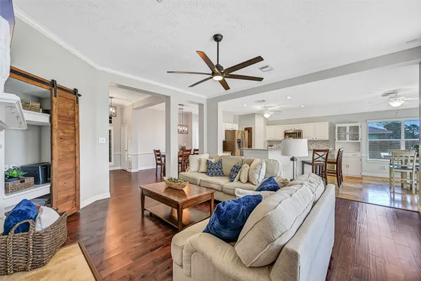 a living room with furniture a ceiling fan and a rug