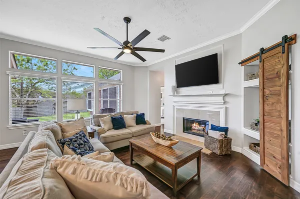 a living room with furniture a fireplace and a flat screen tv