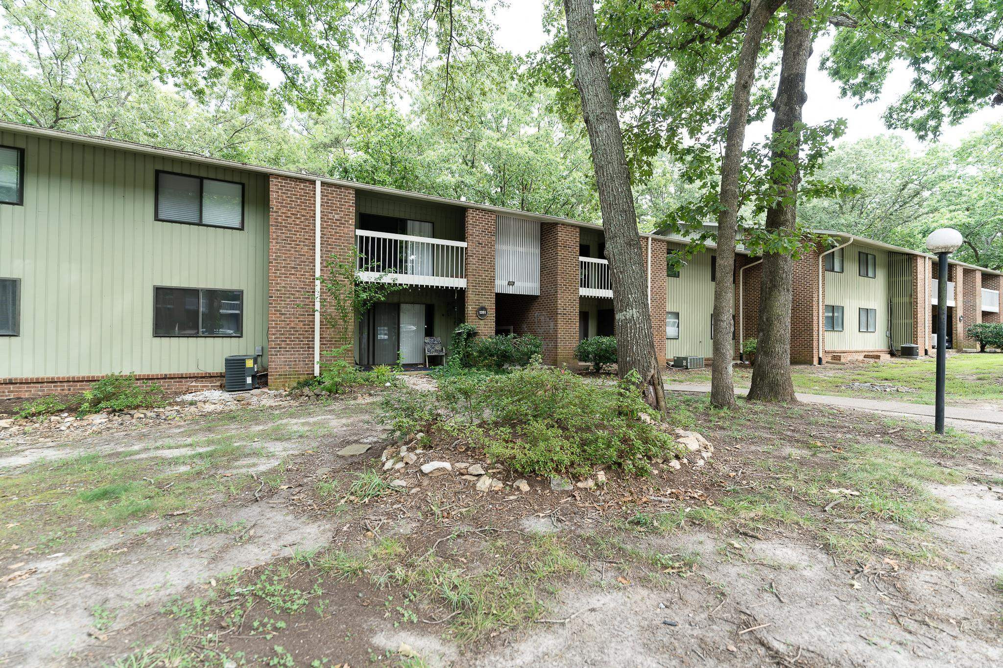 a view of a house with backyard and trees