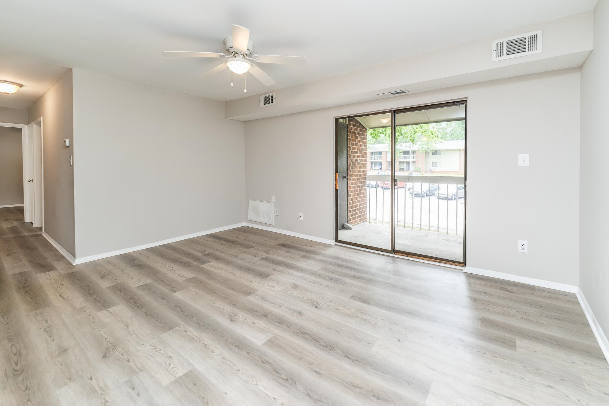 1281 Schaub Drive, Unit G Raleigh, NC 27606 - Photo 2 of 10 wooden floor in an empty room with a window