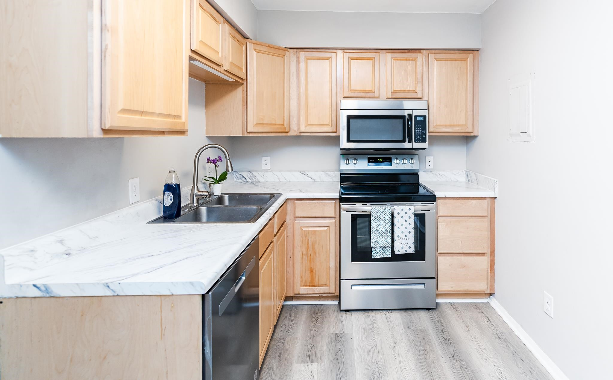 1281 Schaub Drive, Unit G Raleigh, NC 27606 - Photo 3 of 10 a kitchen with granite countertop a stove and a sink