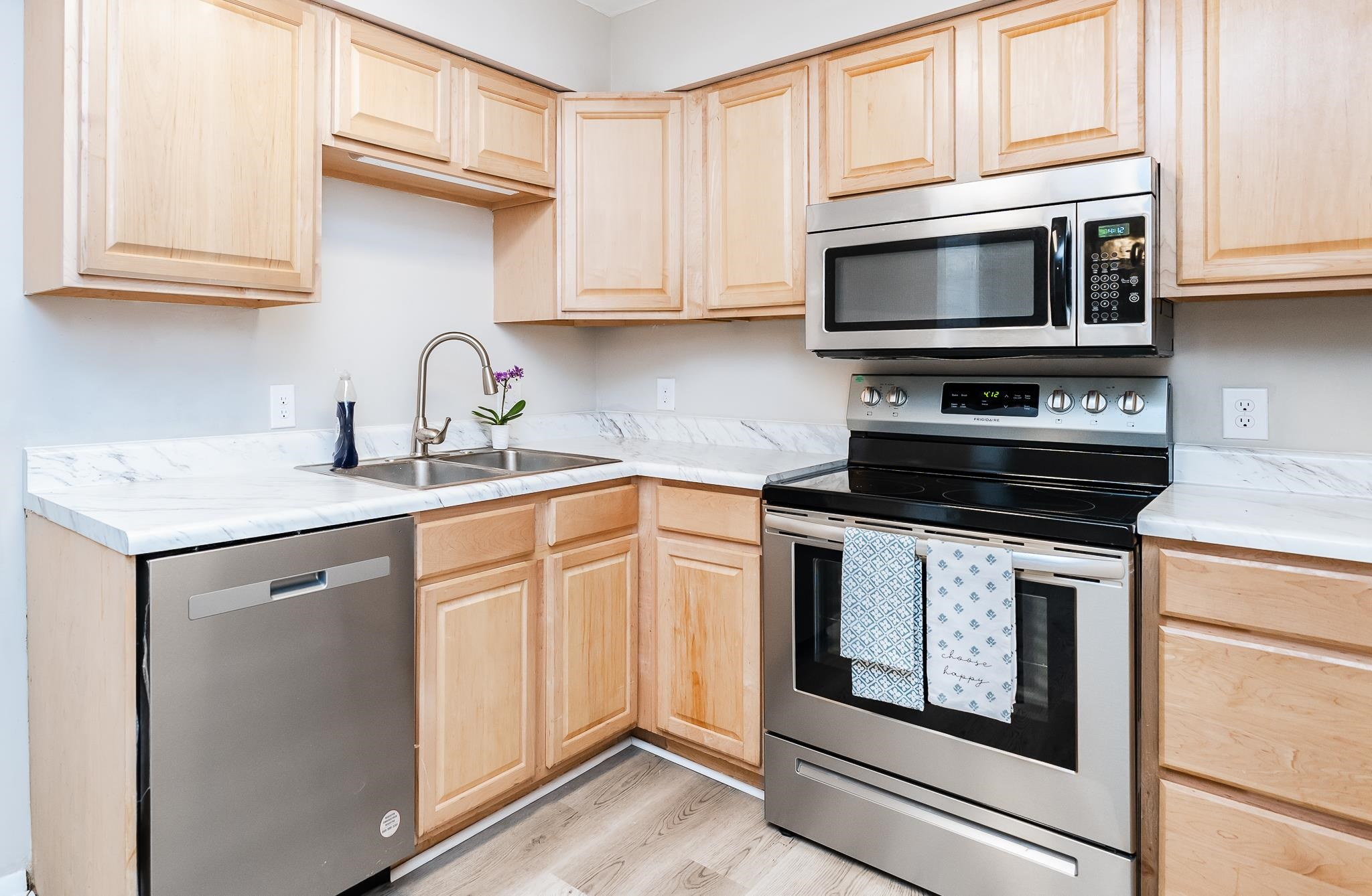 1281 Schaub Drive, Unit G Raleigh, NC 27606 - Photo 4 of 10 a kitchen with granite countertop white cabinets stainless steel appliances and a sink