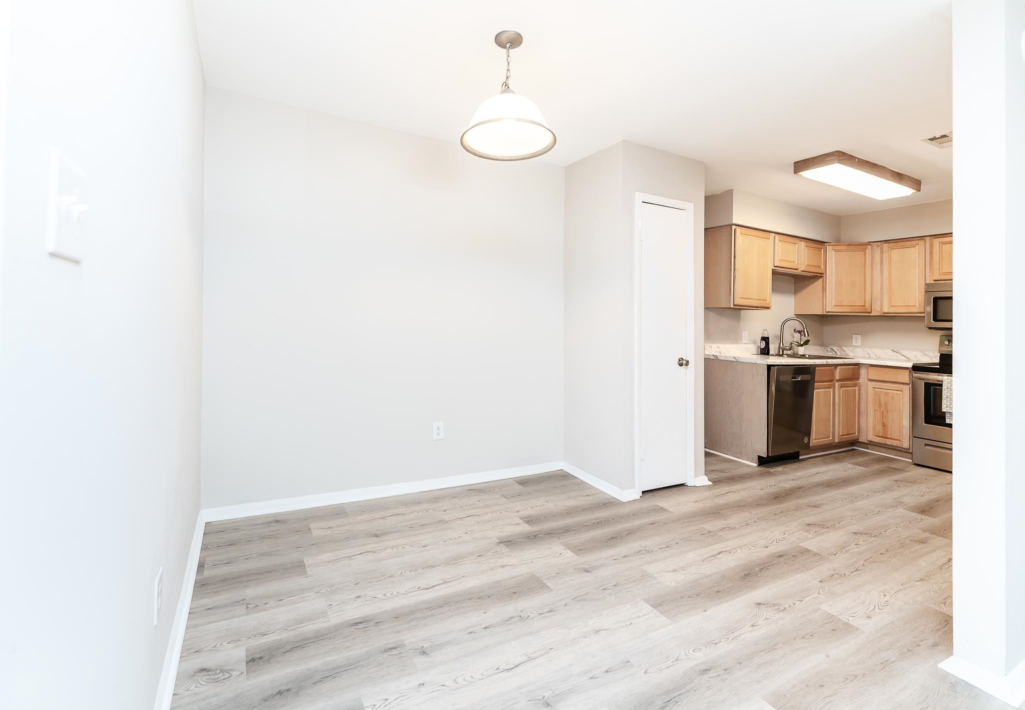 1281 Schaub Drive, Unit G Raleigh, NC 27606 - Photo 5 of 10 a view of kitchen with wooden floor