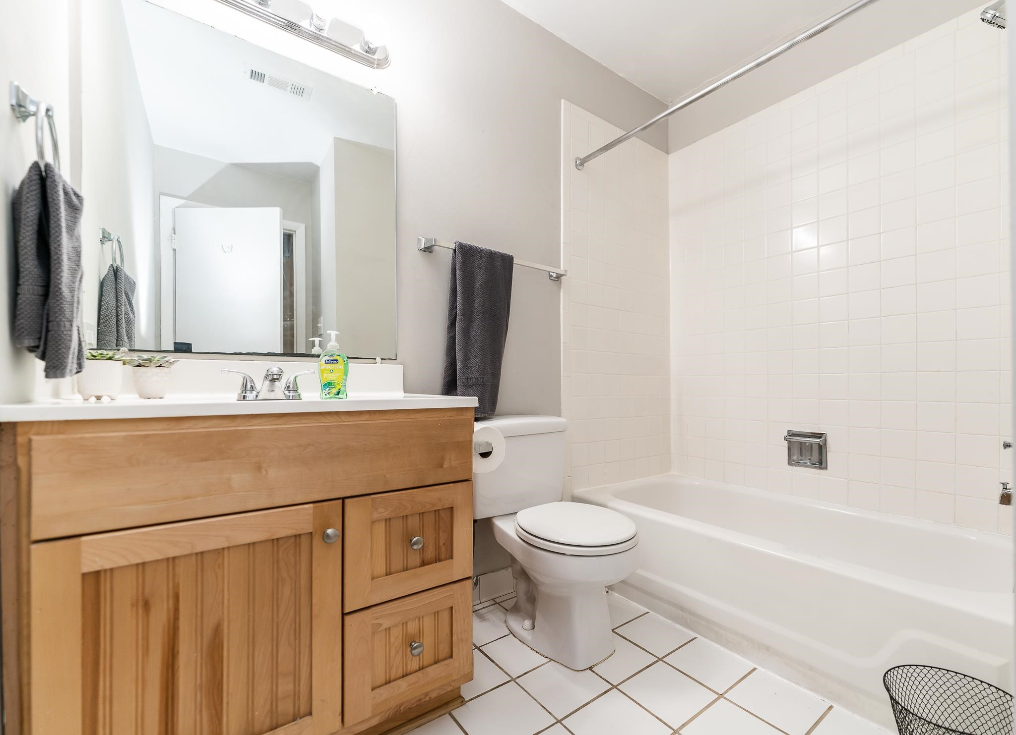 1281 Schaub Drive, Unit G Raleigh, NC 27606 - Photo 8 of 10 a bathroom with a sink toilet a mirror and shower