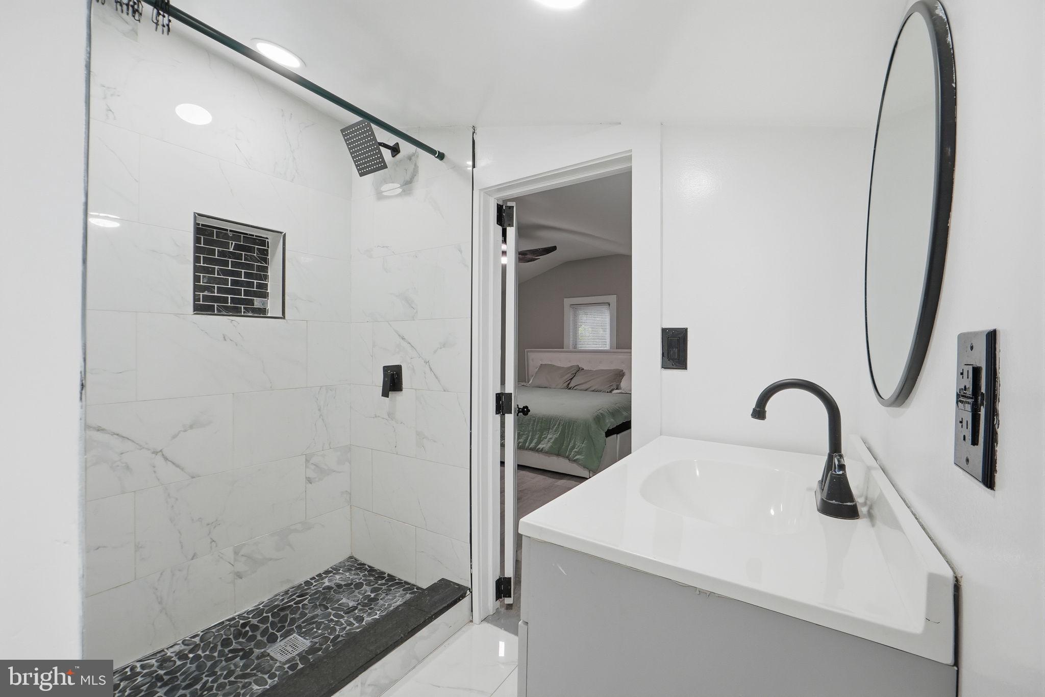 5906 Berwyn Road College Park, MD 20740 - Photo 17 of 46 a bathroom with a sink and a mirror