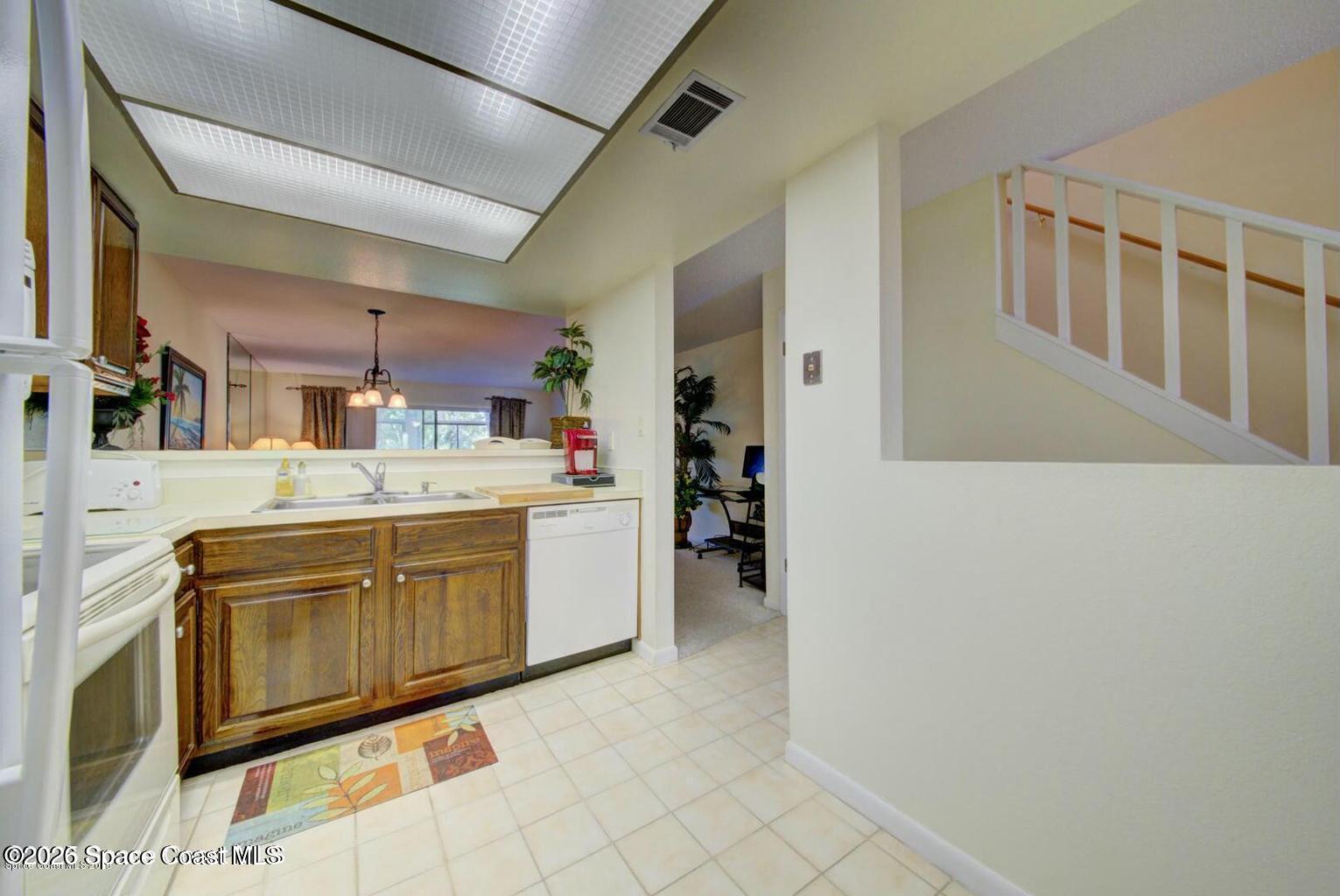 227 Augusta Way Melbourne, FL 32940 - Photo 13 of 38 a kitchen with stainless steel appliances kitchen island granite countertop a refrigerator and a stove