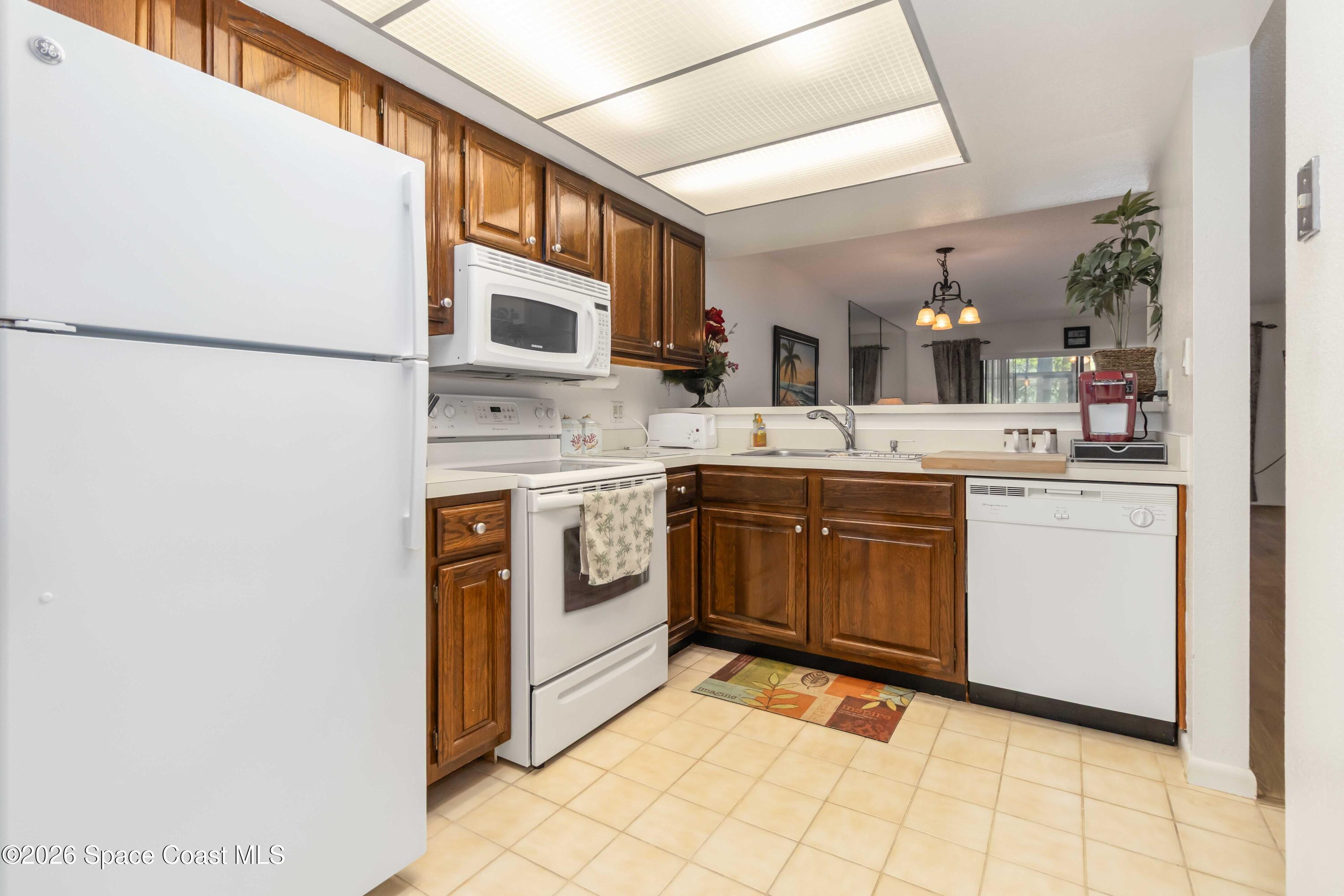 227 Augusta Way Melbourne, FL 32940 - Photo 14 of 38 a kitchen with a sink cabinets and appliances