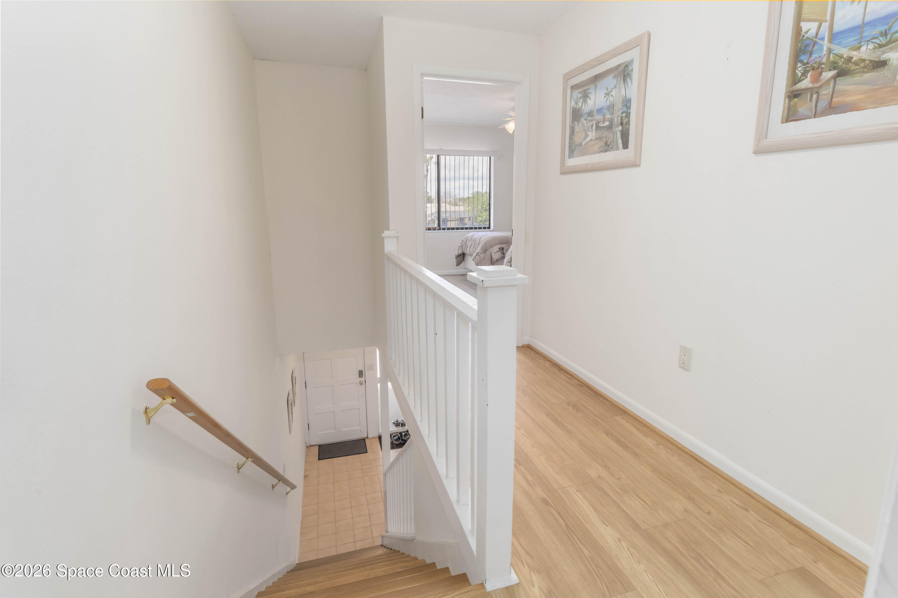 227 Augusta Way Melbourne, FL 32940 - Photo 18 of 38 a view of a hallway with a white walls and wooden floor