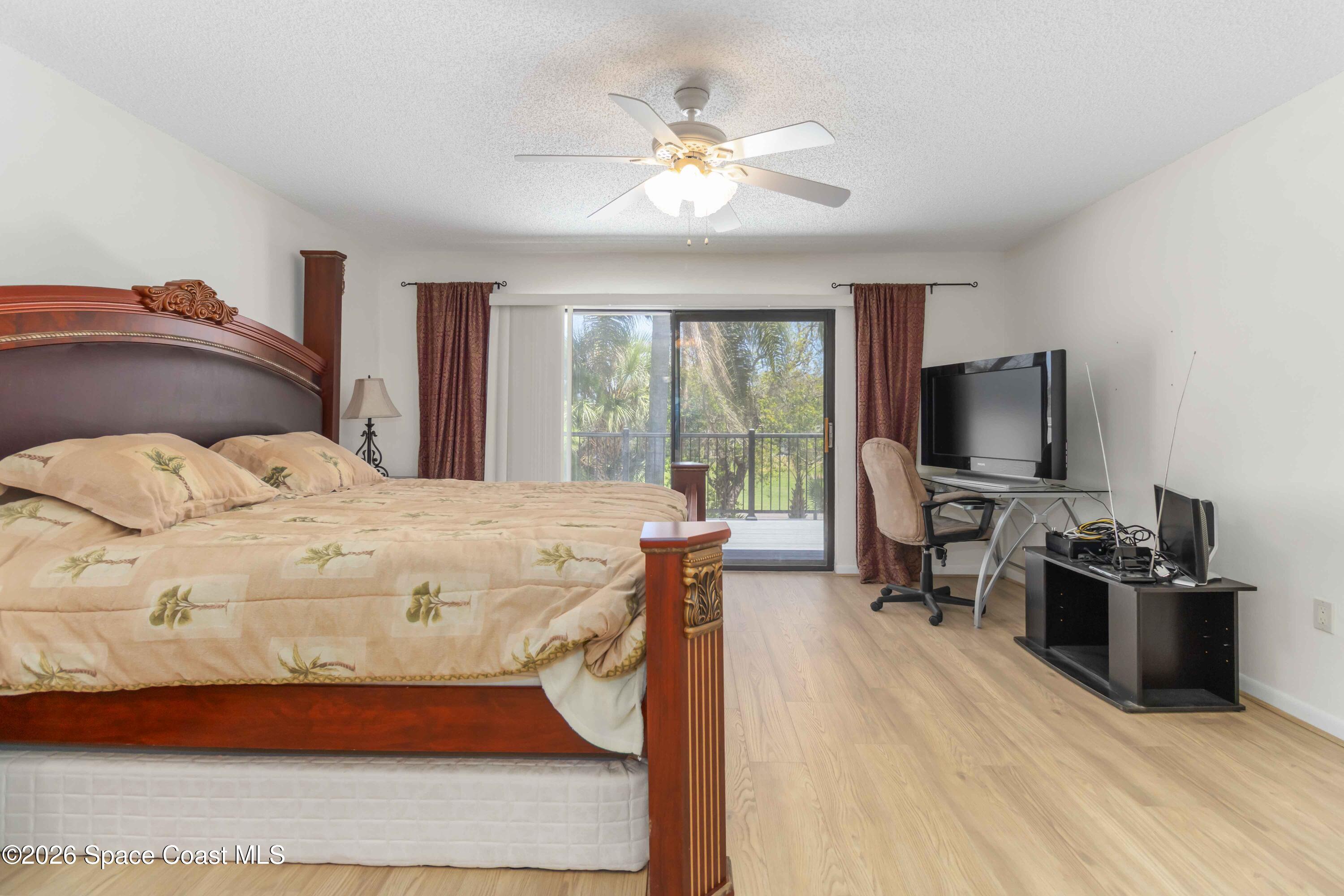 227 Augusta Way Melbourne, FL 32940 - Photo 20 of 38 a bedroom with a bed and a flat screen tv