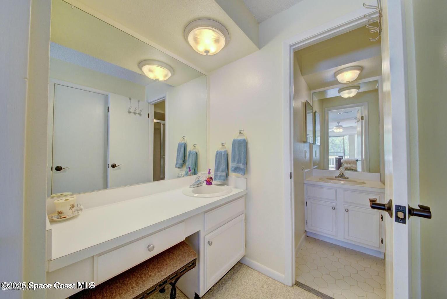 227 Augusta Way Melbourne, FL 32940 - Photo 24 of 38 a bathroom with a double vanity sink and a mirror