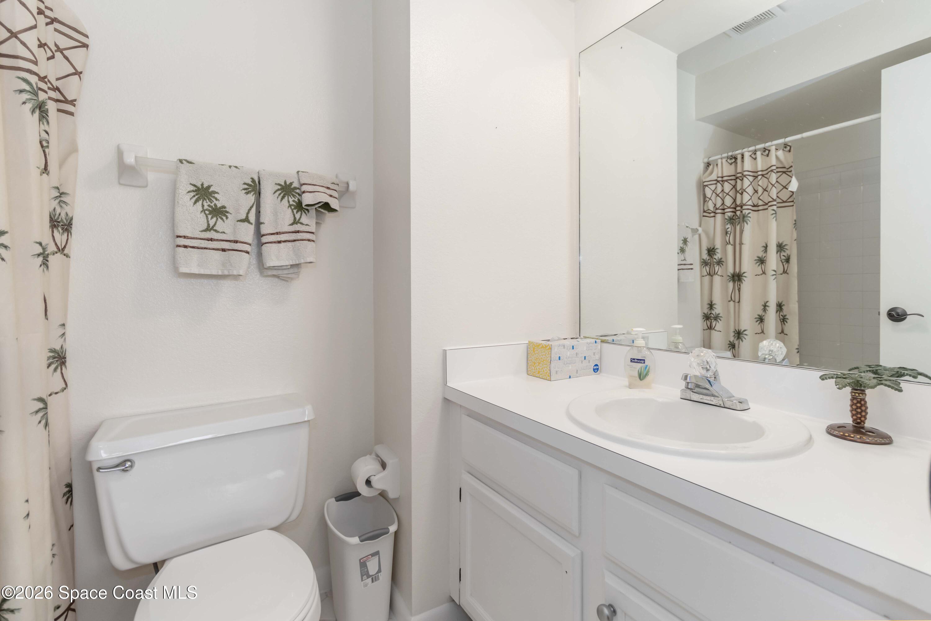 227 Augusta Way Melbourne, FL 32940 - Photo 27 of 38 a bathroom with a toilet sink and mirror