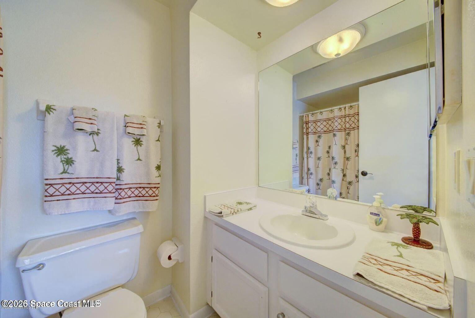 227 Augusta Way Melbourne, FL 32940 - Photo 28 of 38 a bathroom with a sink toilet vanity and tub