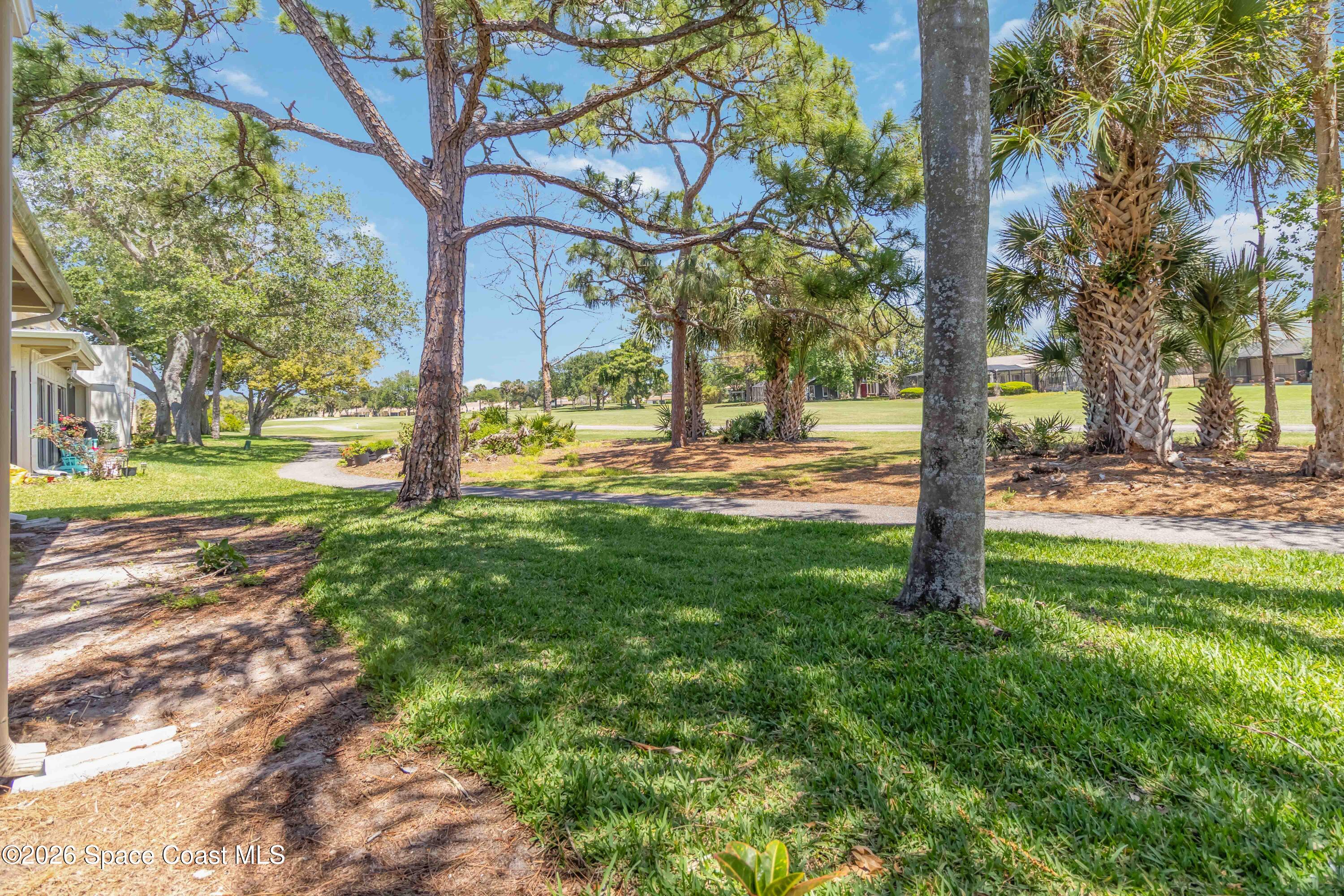 227 Augusta Way Melbourne, FL 32940 - Photo 33 of 38 a view of a yard with a tree