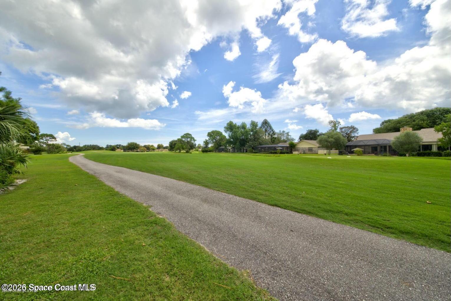 227 Augusta Way Melbourne, FL 32940 - Photo 35 of 38 a view of a golf course with green space