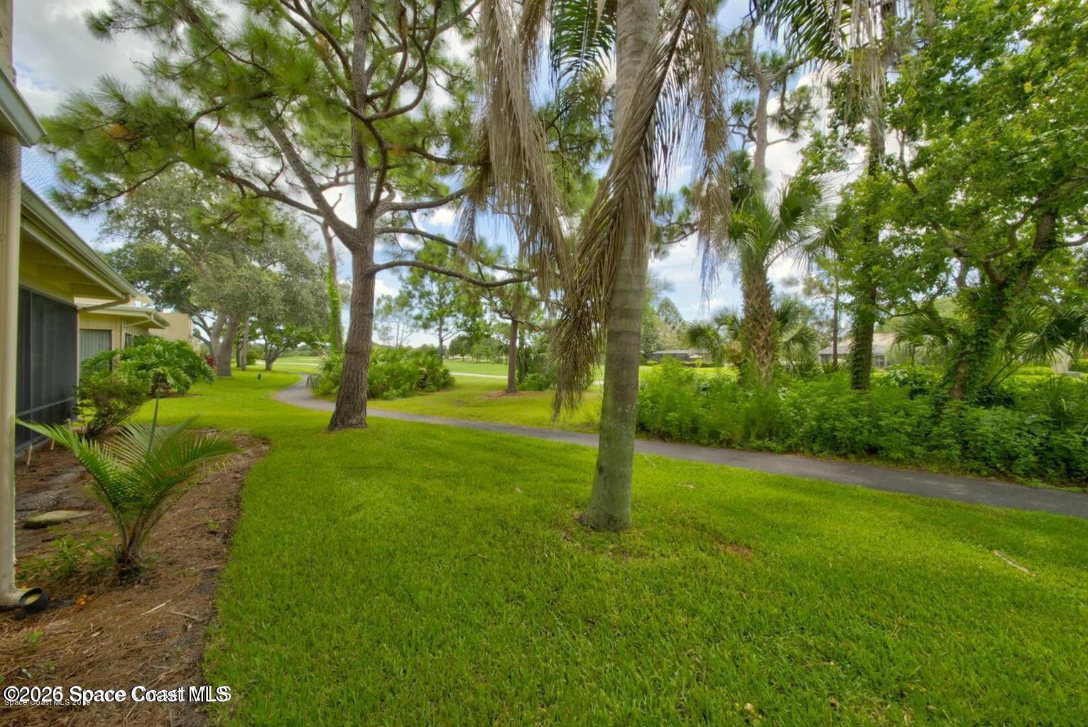 227 Augusta Way Melbourne, FL 32940 - Photo 36 of 38 a view of an trees with a yard
