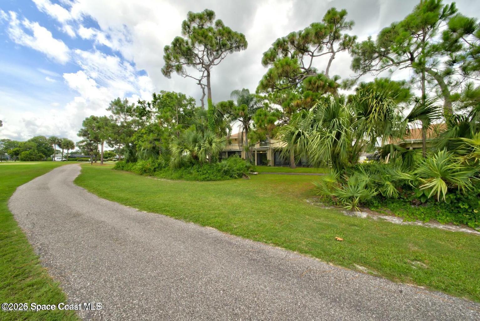 227 Augusta Way Melbourne, FL 32940 - Photo 37 of 38 a view of a garden with a fountain