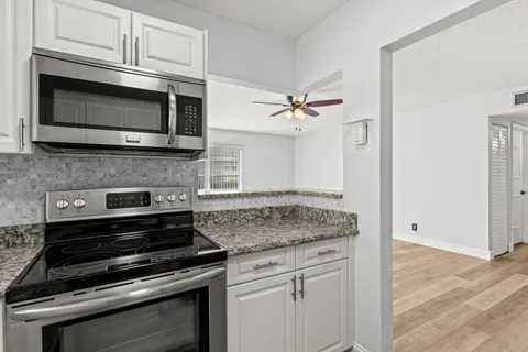 a kitchen with appliances and cabinets