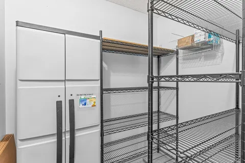 a view of a hallway with wooden cabinets