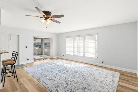 a view of a livingroom with a dining table and window
