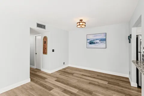 a view of room with window and wooden floor