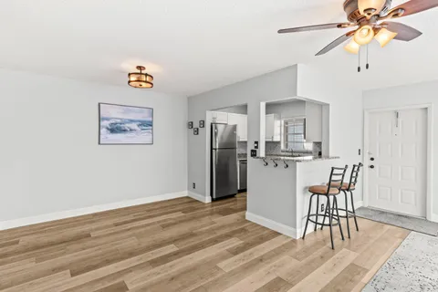 a view of a dining room with furniture and wooden floor