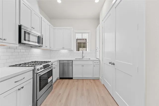 a kitchen with a stove oven and sink