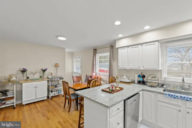 a view of a kitchen area with furniture and wooden floor