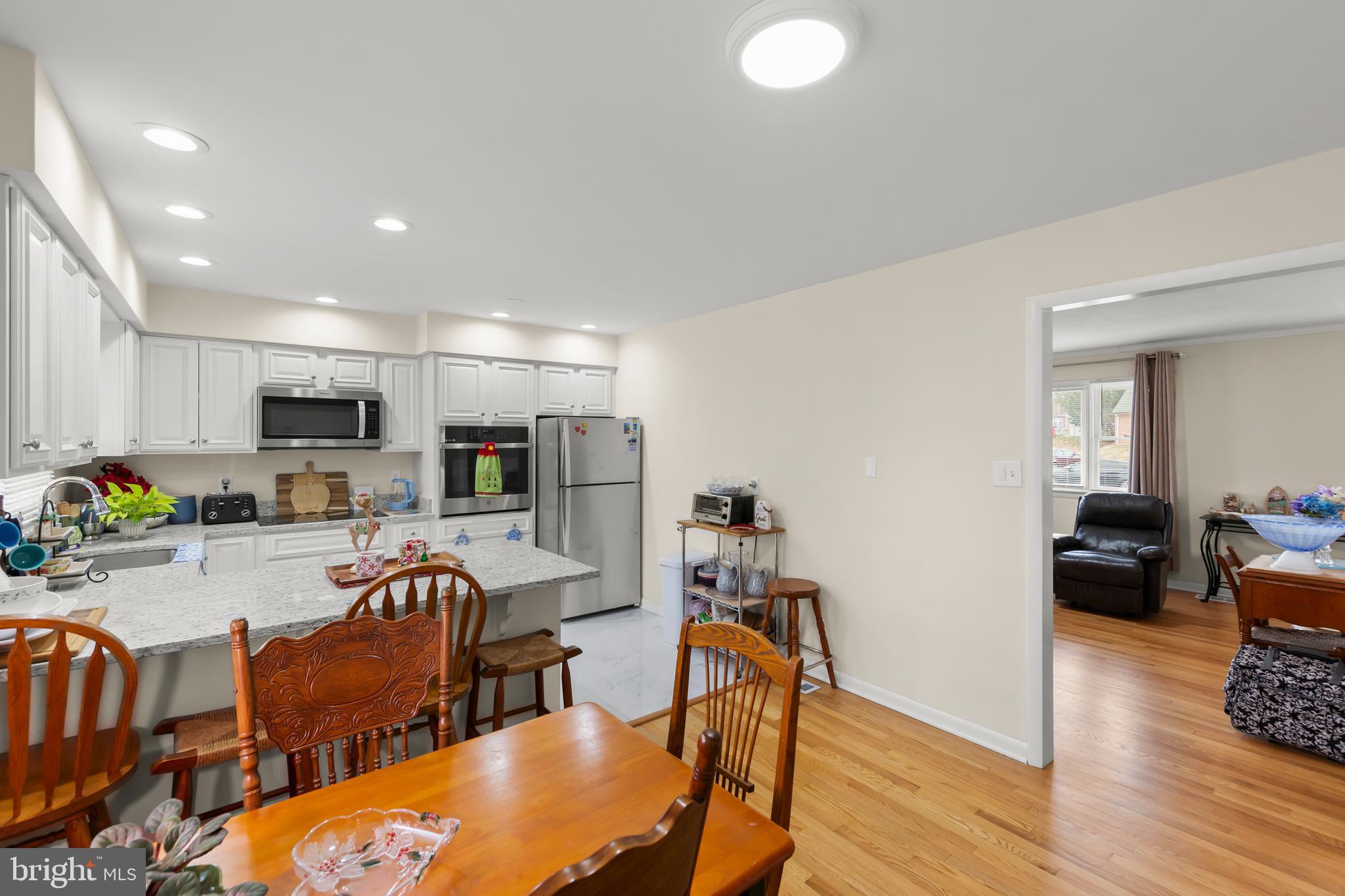 250 Co Rte 340/7 Charles Town, WV 25414 - Photo 14 of 42 a living room with furniture kitchen view and a wooden floor