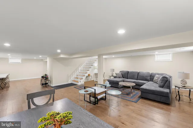 a living room with furniture and kitchen view