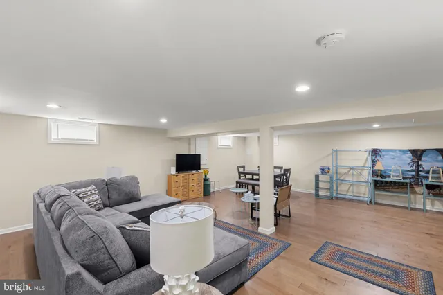 a living room with furniture and a dining table with kitchen view