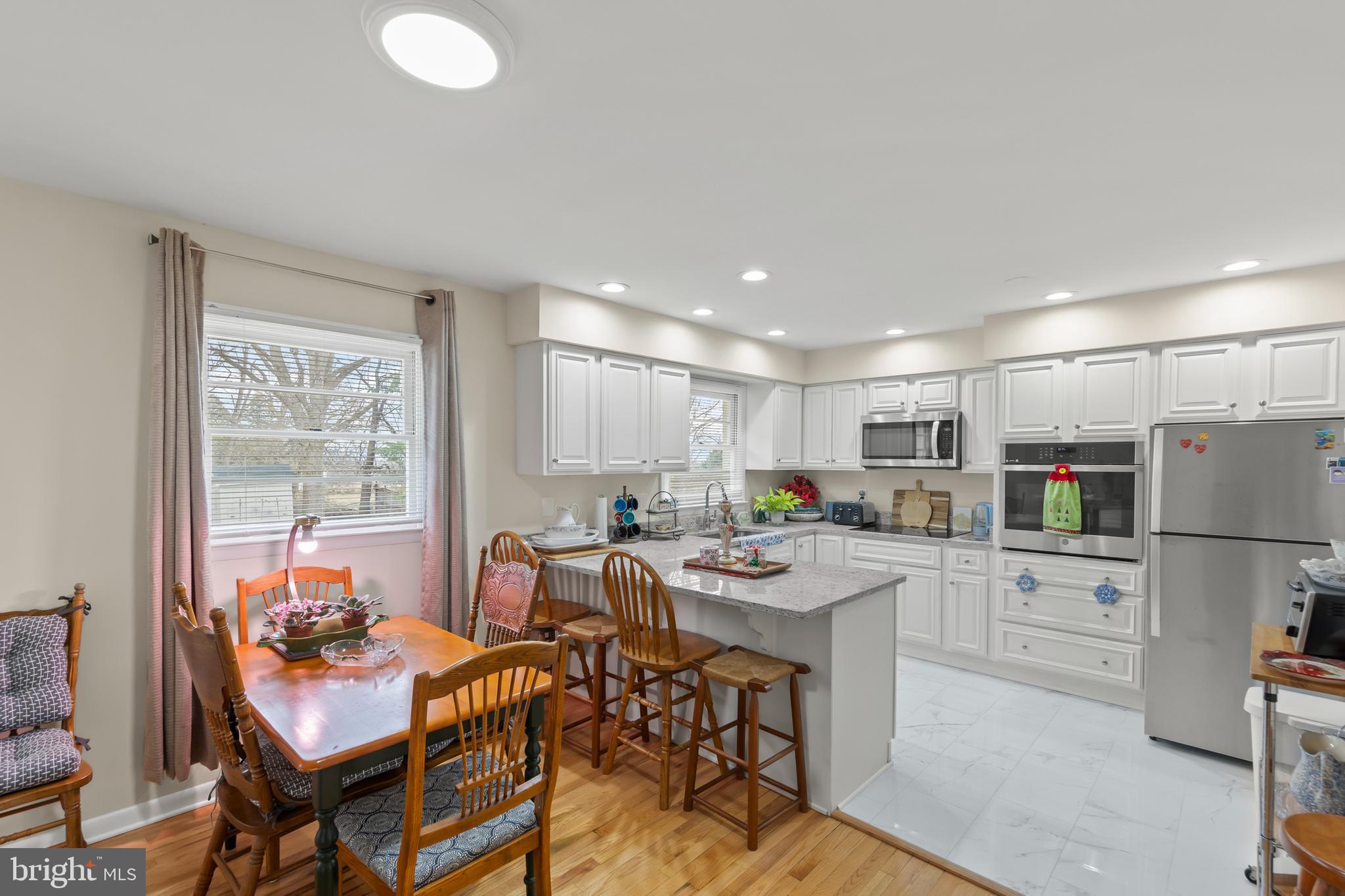 250 Co Rte 340/7 Charles Town, WV 25414 - Photo 7 of 42 a kitchen with stainless steel appliances a table and chairs in it