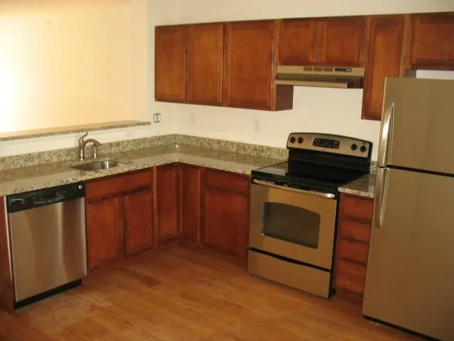 a kitchen with a sink stove and cabinets