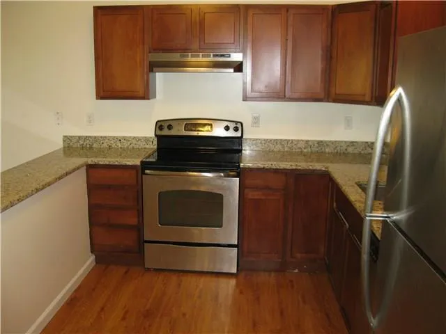 a kitchen with a stove microwave and fridge