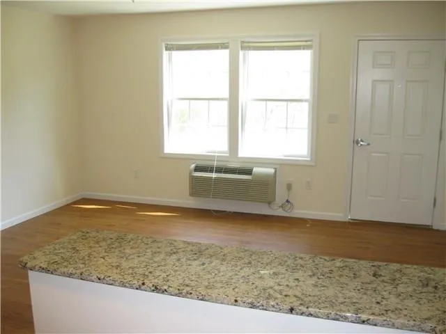 an empty room with wooden floor