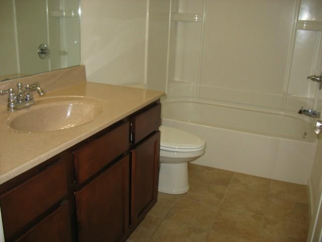 41 Grand Street, Unit 102 Danbury, CT 06810 - Photo 10 of 13 a bathroom with a sink a toilet and shower