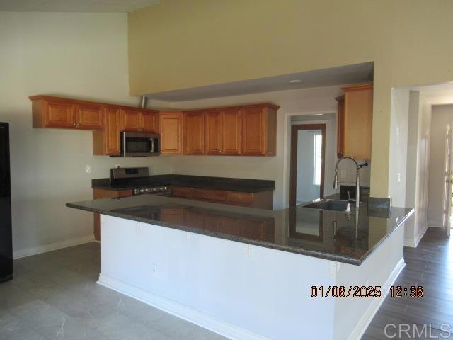 5957 Steeplechase Road Bonita, CA 91902 - Photo 2 of 8 a kitchen with granite countertop a stove and a sink