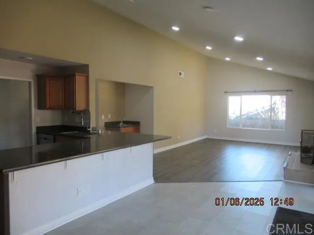 a large kitchen with stainless steel appliances a large counter top and a stove