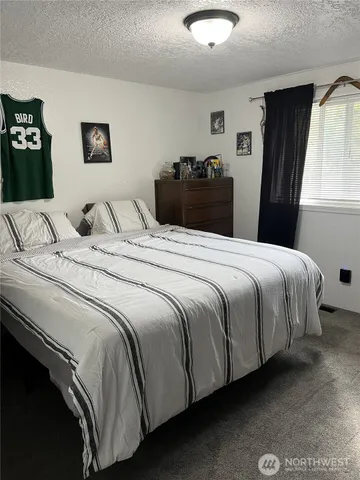 a bedroom with a bed and dresser