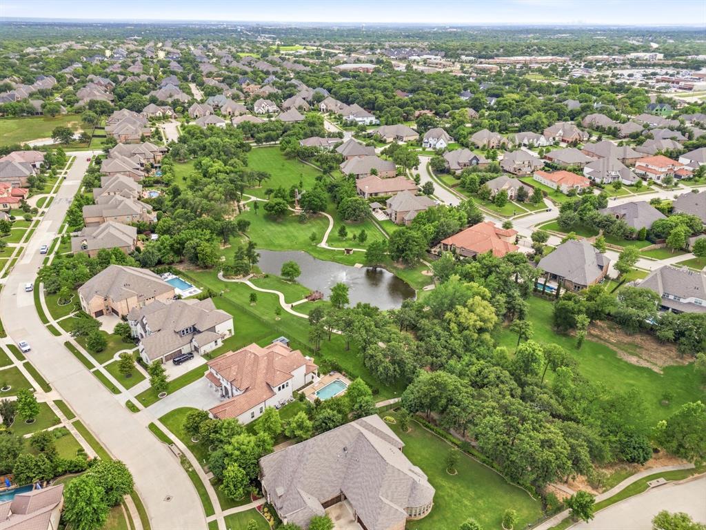 7013 Handel Colleyville, TX 76034 - Photo 35 of 37 Expansive residential neighborhood featuring a central pond, abundant green spaces, winding streets, and mature trees