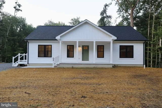 a house that has a large pool in front of it