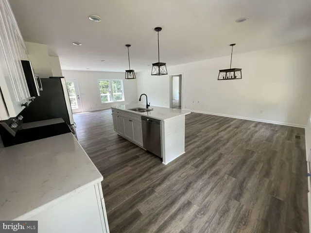 a living room with hard wood floors and furniture