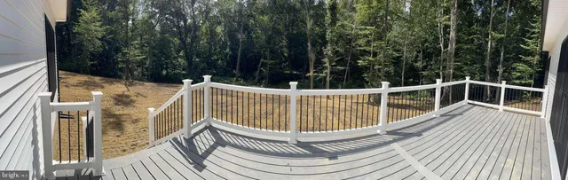 a view of balcony with wooden floor and fence