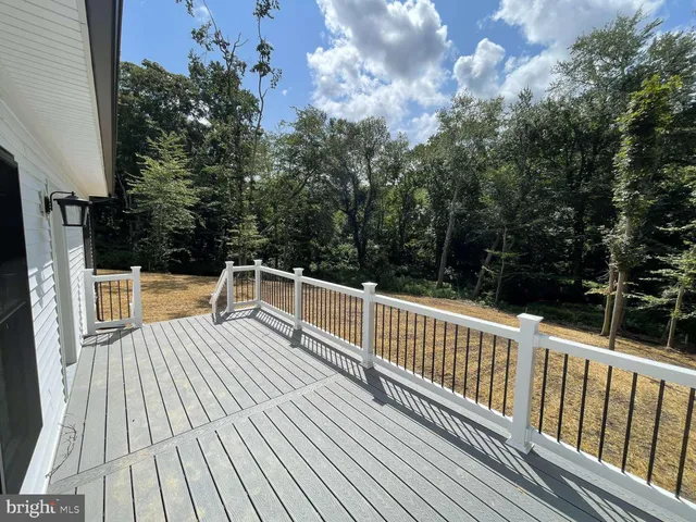 a view of balcony with wooden floor and fence